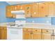Bright kitchen featuring upper cabinets with graphics, tile floor, and white appliances at 91 W Cedarwood Cir, Kissimmee, FL 34743