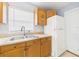 Bright kitchen featuring upper cabinets with graphics, tile floor, and a stainless steel sink at 91 W Cedarwood Cir, Kissimmee, FL 34743