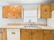 Bright kitchen featuring upper cabinets with graphics, tile floor, and a stainless steel sink at 91 W Cedarwood Cir, Kissimmee, FL 34743