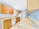 Bright kitchen featuring upper cabinets with graphics, tile floor, and a white appliances at 91 W Cedarwood Cir, Kissimmee, FL 34743