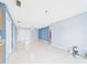 Living room with ceramic tile and blue walls at 91 W Cedarwood Cir, Kissimmee, FL 34743