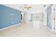 Open living room with ceramic tile and natural light at 91 W Cedarwood Cir, Kissimmee, FL 34743