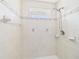 Bright shower features tile and a glass block window at 91 W Cedarwood Cir, Kissimmee, FL 34743