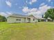 Well-maintained home with lush green yard and mature trees at 91 W Cedarwood Cir, Kissimmee, FL 34743