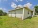 Well-maintained side yard with green grass at 91 W Cedarwood Cir, Kissimmee, FL 34743