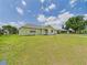 Well-maintained home with lush green yard and mature trees at 91 W Cedarwood Cir, Kissimmee, FL 34743