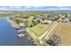 Aerial view of a lakeside home with a large backyard, private dock, and mature trees at 9502 Waterford Oaks Blvd, Winter Haven, FL 33884