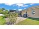 A view of the backyard featuring a brick patio and screened in porch at 9502 Waterford Oaks Blvd, Winter Haven, FL 33884