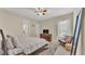 Comfortable bedroom with a ceiling fan, carpeted floor, and a view into the bathroom at 9502 Waterford Oaks Blvd, Winter Haven, FL 33884