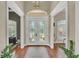 Elegant foyer with hardwood floors, decorative doors, and transom window at 9502 Waterford Oaks Blvd, Winter Haven, FL 33884
