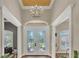 Front foyer featuring double doors and grand chandelier at 9502 Waterford Oaks Blvd, Winter Haven, FL 33884