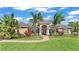 Charming home with lush landscaping, manicured lawn, and a welcoming brick walkway at 9502 Waterford Oaks Blvd, Winter Haven, FL 33884