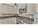 Close-up of kitchen features stainless steel oven, microwave, and traditional cabinetry at 9502 Waterford Oaks Blvd, Winter Haven, FL 33884