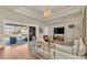 Bright living room with chandelier, hardwood floors, and sliding glass doors to pool at 9502 Waterford Oaks Blvd, Winter Haven, FL 33884