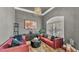 Stylish living room featuring a plush sofa, unique coffee table, and modern decor at 9502 Waterford Oaks Blvd, Winter Haven, FL 33884