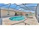 Screened in pool area with brick pavers, inground pool and spa, and backyard views at 9502 Waterford Oaks Blvd, Winter Haven, FL 33884