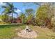 Lush backyard featuring a decorative fountain, landscaping, and partial fencing at 995 14Th Ne St, Winter Haven, FL 33881