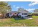 Well-maintained backyard with lush landscaping, a cozy patio, and charming curb appeal at 995 14Th Ne St, Winter Haven, FL 33881