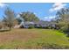 View of the backyard with a spacious lawn and the home's exterior at 995 14Th Ne St, Winter Haven, FL 33881