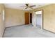 Bedroom featuring a ceiling fan, closet and exterior doors at 995 14Th Ne St, Winter Haven, FL 33881