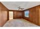 Bedroom featuring wood-paneled walls and a ceiling fan at 995 14Th Ne St, Winter Haven, FL 33881