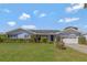 Charming single-story home with manicured lawn, colorful plantings, and attached garage at 995 14Th Ne St, Winter Haven, FL 33881