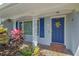 Inviting front porch featuring decorative columns and a brightly colored front door at 995 14Th Ne St, Winter Haven, FL 33881