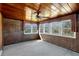 Sunroom featuring multiple windows, ceiling fan, and wood-paneled walls and ceiling at 995 14Th Ne St, Winter Haven, FL 33881
