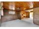 Living room with decorative wood panel walls and ceiling at 995 14Th Ne St, Winter Haven, FL 33881