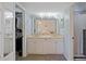 Spacious bathroom with double sink vanity, large mirrors, and access to closet and shower at 1104 Country Club Dr # A-4, Lake Wales, FL 33898