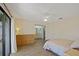 Serene bedroom boasts neutral walls, wood floors, and an ensuite bathroom at 1104 Country Club Dr # A-4, Lake Wales, FL 33898