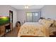 Inviting bedroom with light purple walls, closet, and sliding glass door for natural light at 1104 Country Club Dr # A-4, Lake Wales, FL 33898