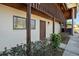 Condo entrance with a wood door, exterior stairs, and neat landscaping at 1104 Country Club Dr # A-4, Lake Wales, FL 33898