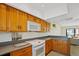 Cozy kitchen with oak cabinets, stainless steel appliances, and hardwood floors at 1104 Country Club Dr # A-4, Lake Wales, FL 33898