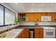 Updated kitchen featuring oak cabinets, stainless steel appliances, and natural light at 1104 Country Club Dr # A-4, Lake Wales, FL 33898