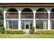 Condo patio with a privacy screen, arched windows, and a well-maintained lawn at 1104 Country Club Dr # A-4, Lake Wales, FL 33898