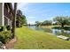 Scenic water view of the condo community with lush green lawns and mature trees at 1104 Country Club Dr # A-4, Lake Wales, FL 33898