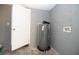 Unfinished basement with utility connections and water heater at 1328 3Rd Ne St, Winter Haven, FL 33881