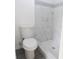 White toilet with walk-in shower in renovated bathroom at 1328 3Rd Ne St, Winter Haven, FL 33881