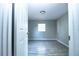 Cozy bedroom featuring wood-look flooring, neutral walls, and natural light at 1328 3Rd Ne St, Winter Haven, FL 33881