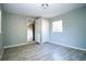Bedroom featuring gray walls, wood-look flooring, a closet, and natural light at 1328 3Rd Ne St, Winter Haven, FL 33881