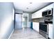 Well-equipped kitchen with stainless steel appliances, white cabinets, and gray walls at 1328 3Rd Ne St, Winter Haven, FL 33881
