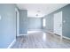 Open living area featuring neutral paint, laminate flooring, and ample natural light at 1328 3Rd Ne St, Winter Haven, FL 33881