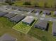 An aerial view of the property highlighting the backyard, landscaping, and surrounding neighborhood at 1340 Oak Valley Drive, Auburndale, FL 33823