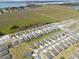 An aerial view of a new community with modern homes, green spaces, and a scenic lake in the distance at 1340 Oak Valley Drive, Auburndale, FL 33823