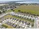 An aerial view of a new community with modern homes, green spaces, and a scenic lake in the distance at 1340 Oak Valley Drive, Auburndale, FL 33823