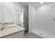 Bathroom featuring double granite sinks, a large mirror, and a tiled walk-in shower at 1340 Oak Valley Drive, Auburndale, FL 33823