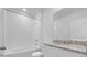 Well-lit bathroom featuring a shower-tub combo and a granite vanity at 1340 Oak Valley Drive, Auburndale, FL 33823