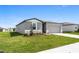 Beautifully landscaped single-Gathering home with a well-maintained lawn and inviting entrance at 1340 Oak Valley Drive, Auburndale, FL 33823