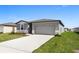 Charming single-Gathering home featuring a driveway, lush lawn, and inviting facade at 1340 Oak Valley Drive, Auburndale, FL 33823